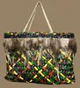 Handwoven multicoloured dyed Harakeke traditional Maori Kete with feathers by New Zealand artist Bernie Ross, available at The Little Gallery Tairua